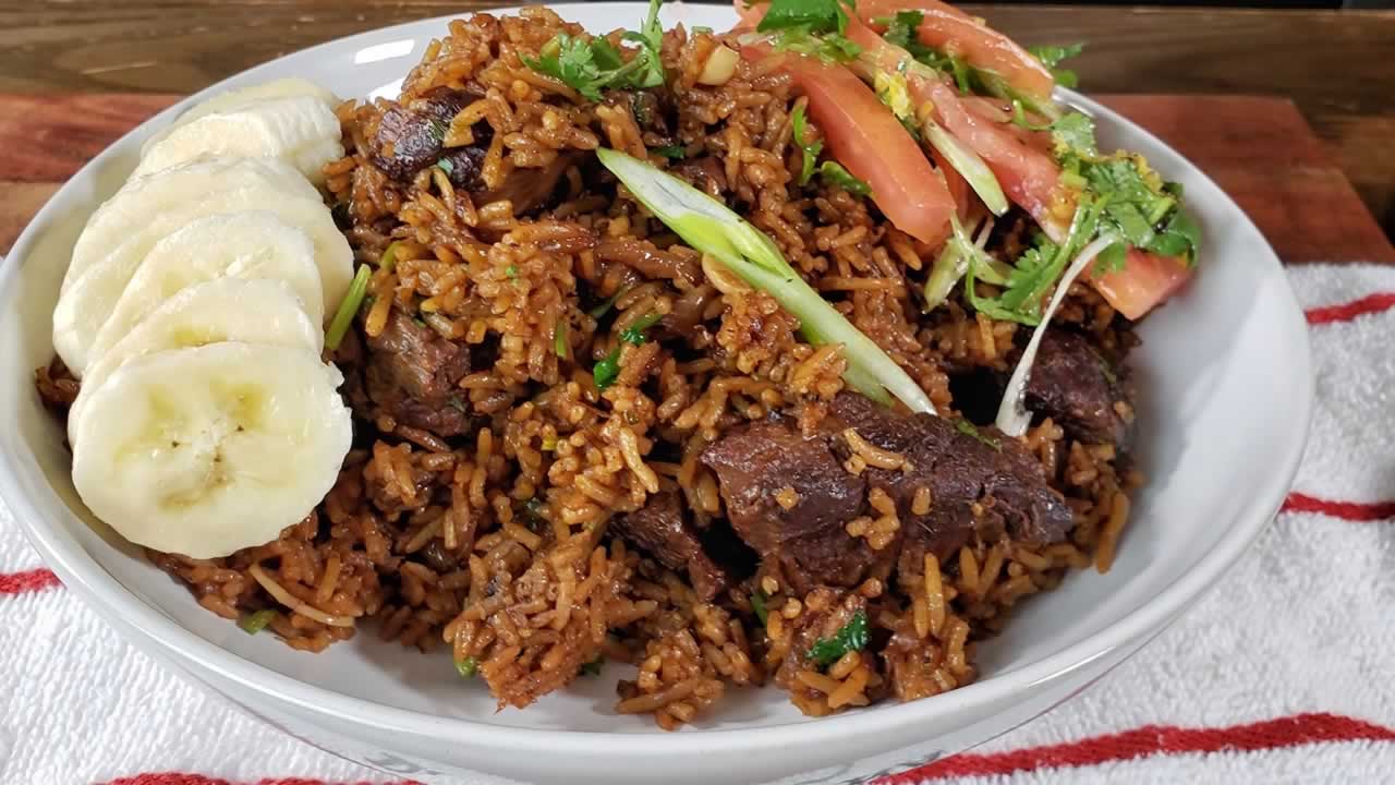 A delicious plate of beef pilau with a side of kachumbari